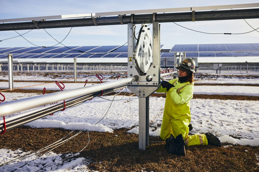 Worker working on a structure in a snowy field
