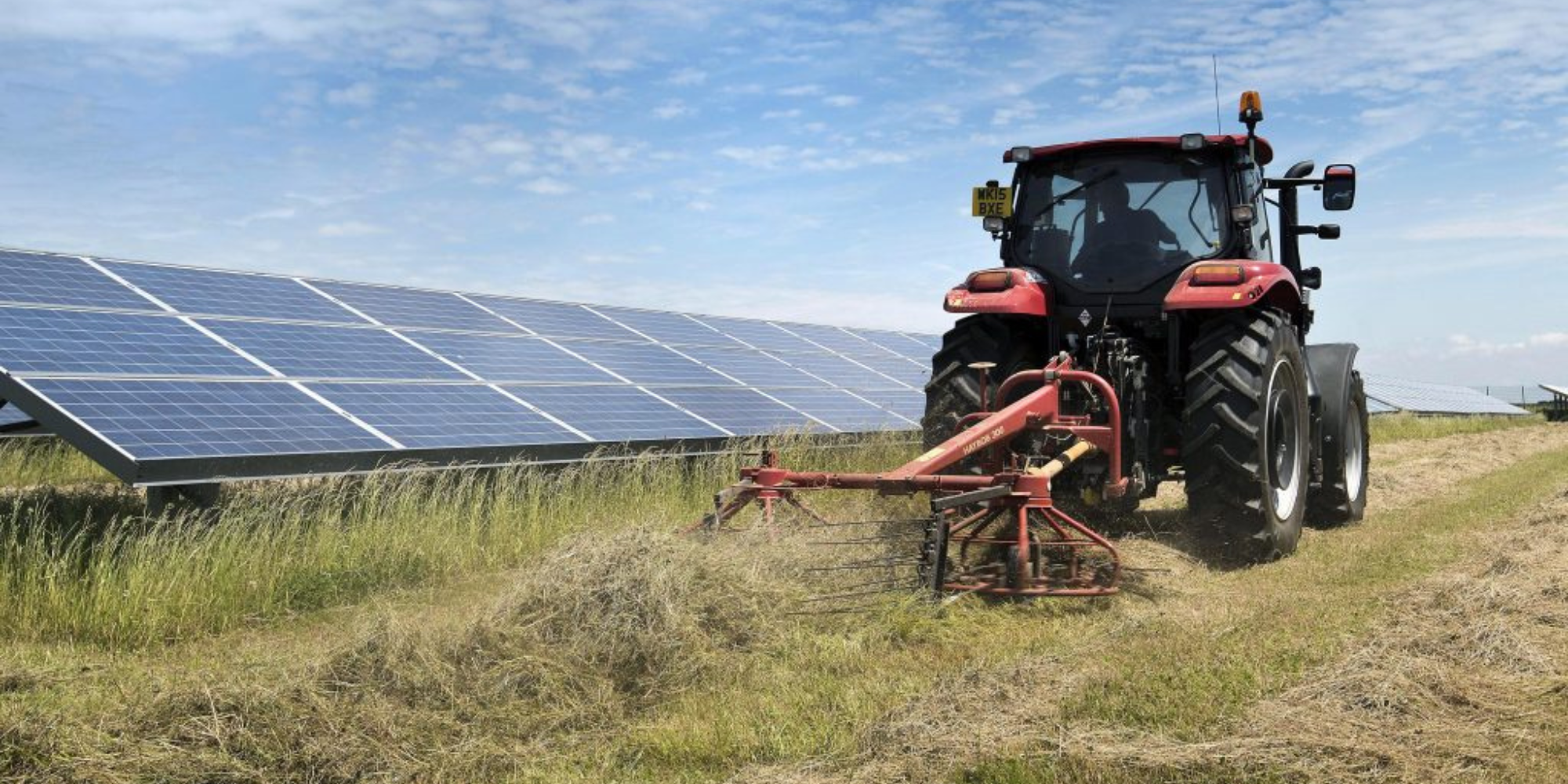 tractor bailing on solar field