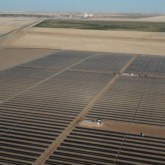 Aerial image of rows of solar panels on a solar farm