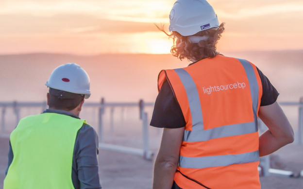 people in hi-viz on solar field