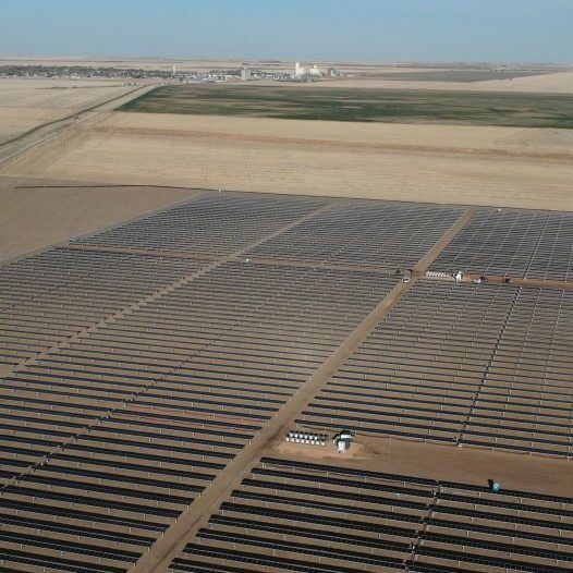 Aerial image of rows of solar panels on a solar farm