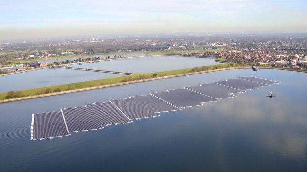 Aerial image of rows of solar panels on a lake