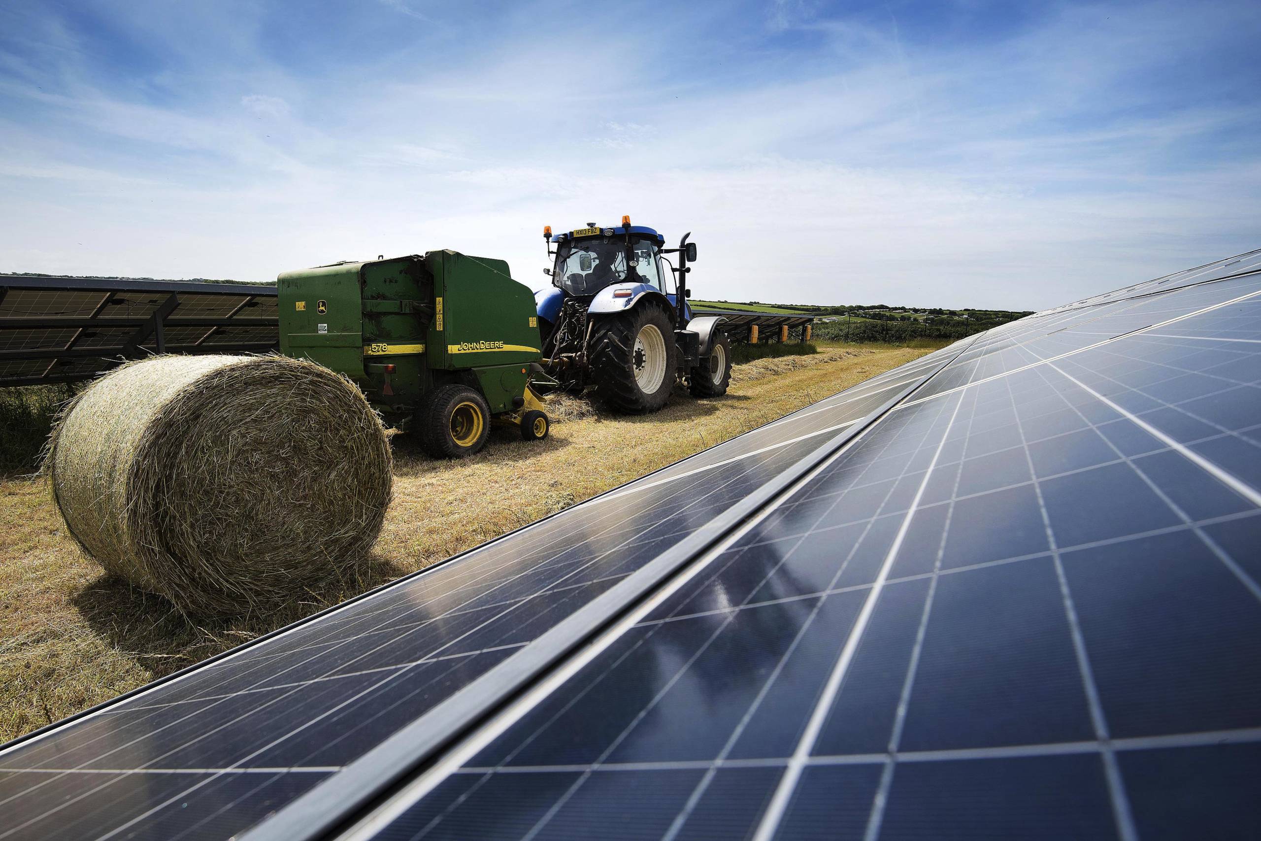 Tractor bailing on solar farm