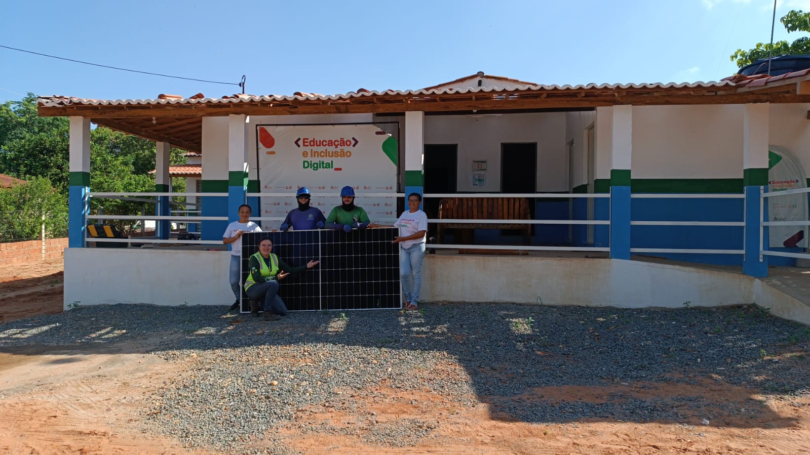 School teachers and Installers with new solar panels for the school