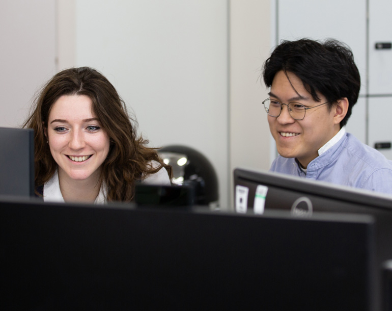 Two people working at a desk