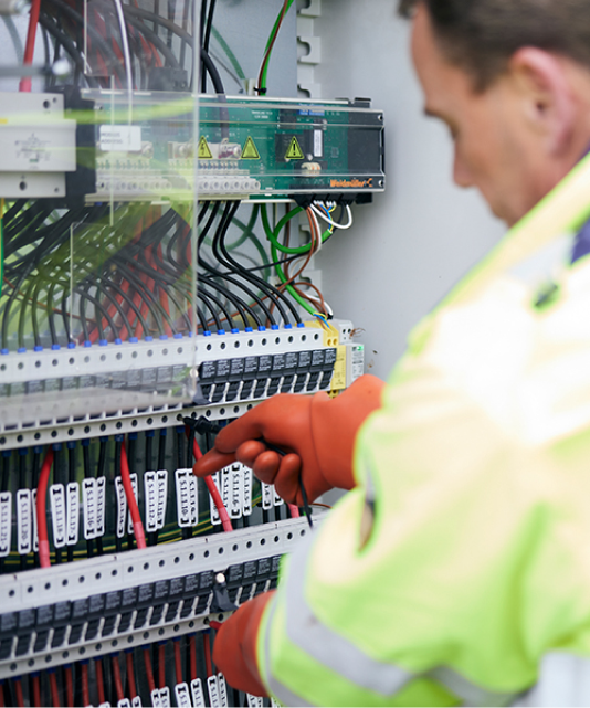 Worker in high-vis gear working on cables