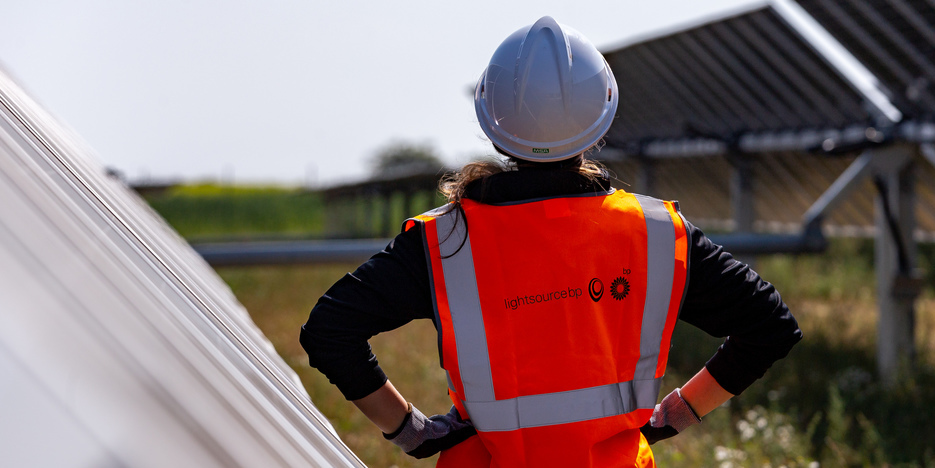 woman in PPE on a solar farm